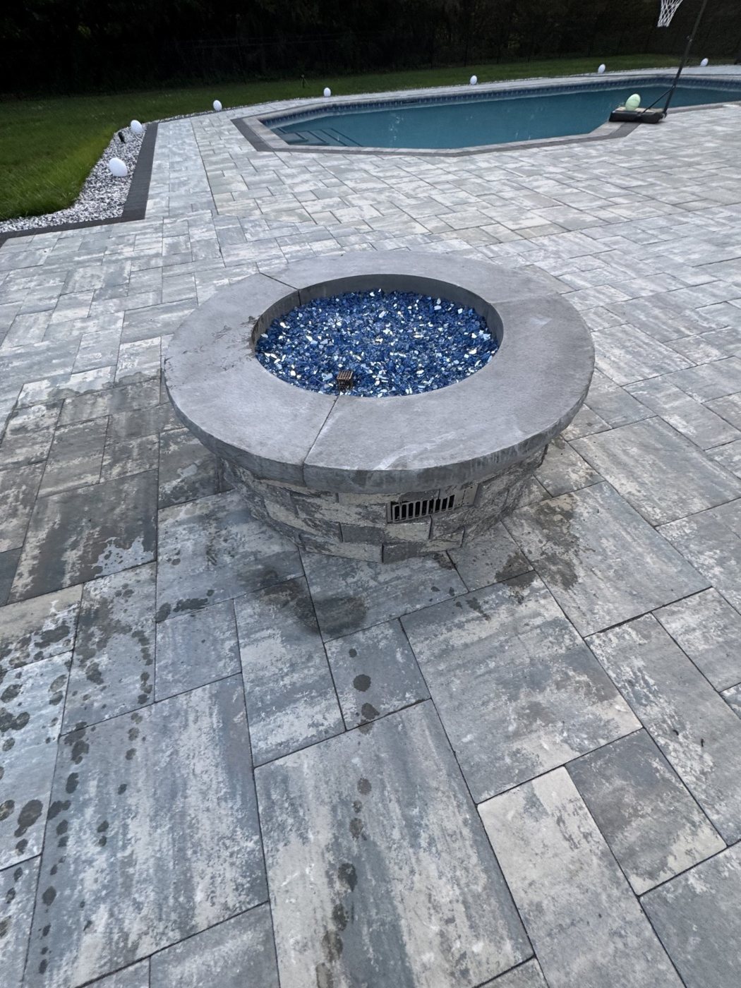 Custom stone fire pit and poolside patio