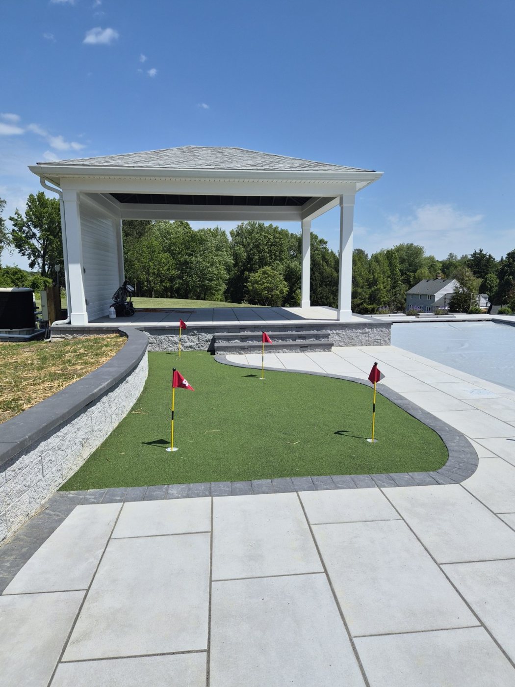 Poolside pavilion and backyard putting green