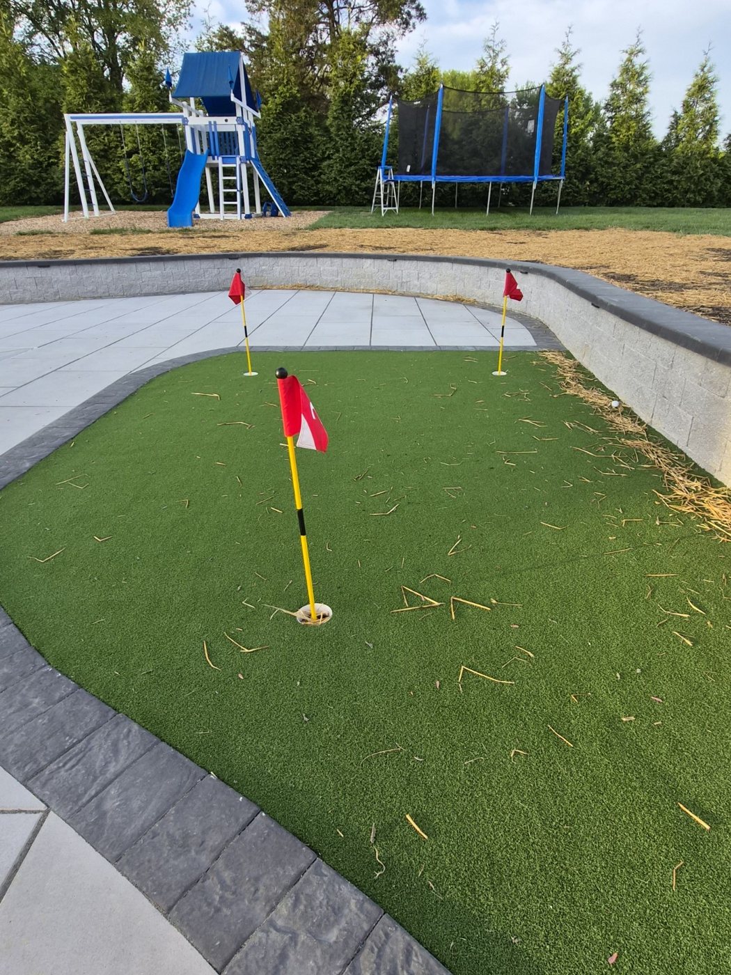 Backyard putting green and retaining wall